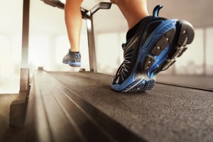 Man running in a gym on a treadmill concept for exercising, fitn